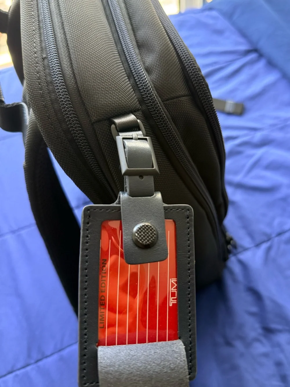 Tumi Black Bag with Red Limited-Edition Tag